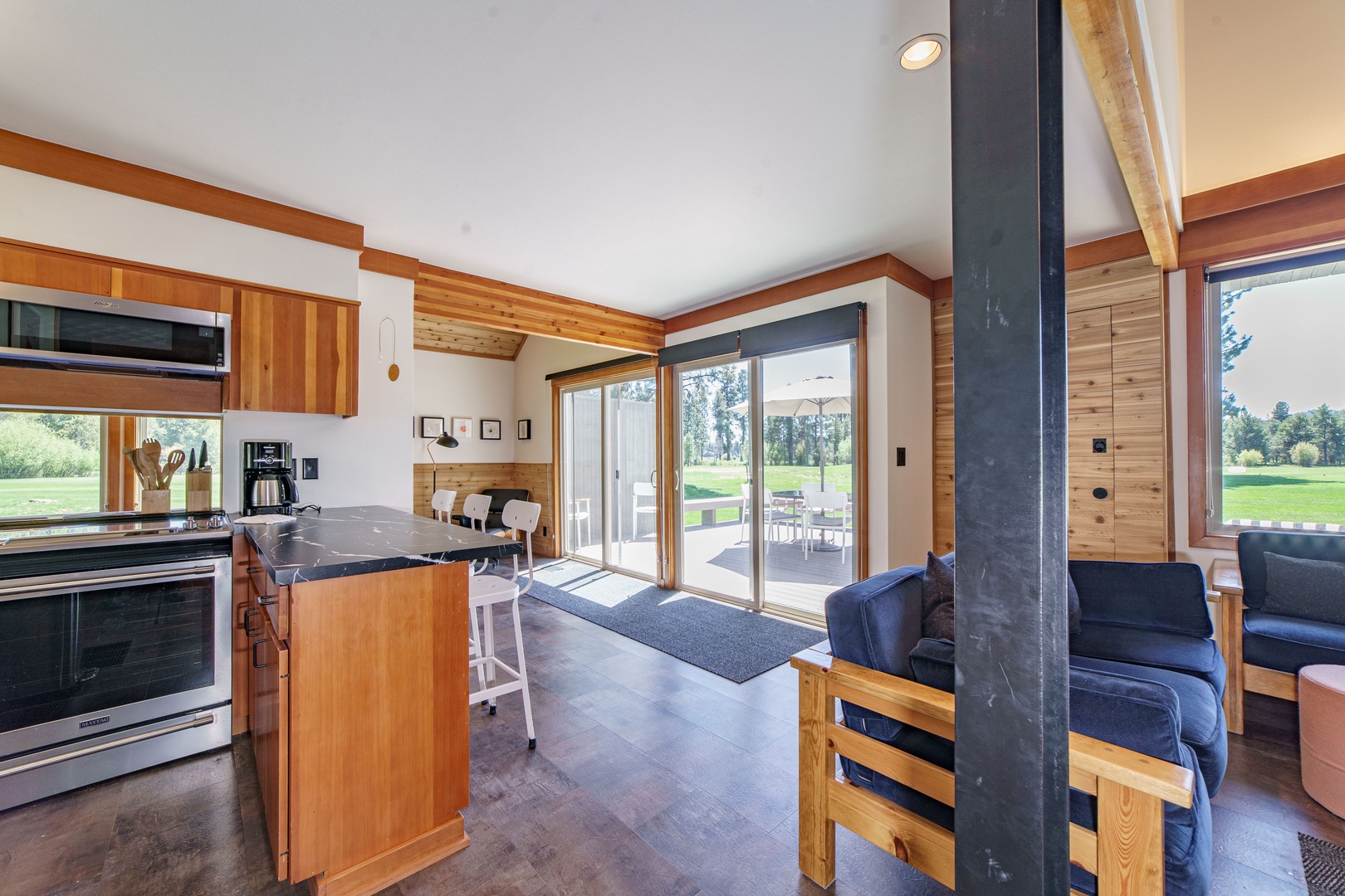 Unwind in your open-concept retreat where warm wood tones meet modern comfort, with a fully-equipped kitchen flowing into your cozy living space.