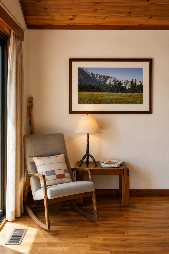 Settle into your cozy reading nook with a warm lamp, comfortable rocking chair, and mountain art above—perfect for unwinding after a day of exploring.