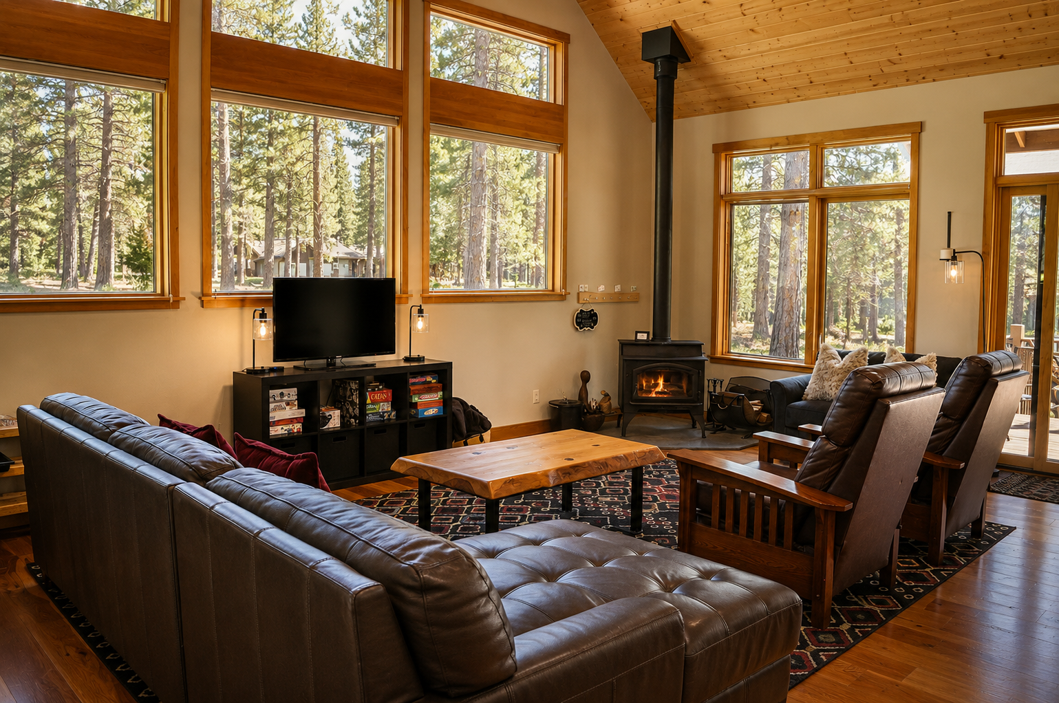 Gather around the crackling fireplace with forest views framing your relaxation. Plush leather seating and soaring ceilings create your perfect mountain retreat.