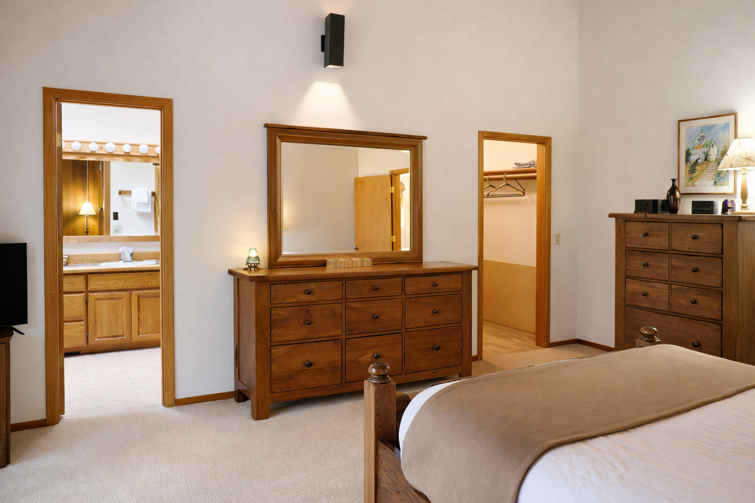 Your spacious bedroom features rich wood furnishings and thoughtful touches, with an ensuite bathroom and generous closet space for all your belongings.