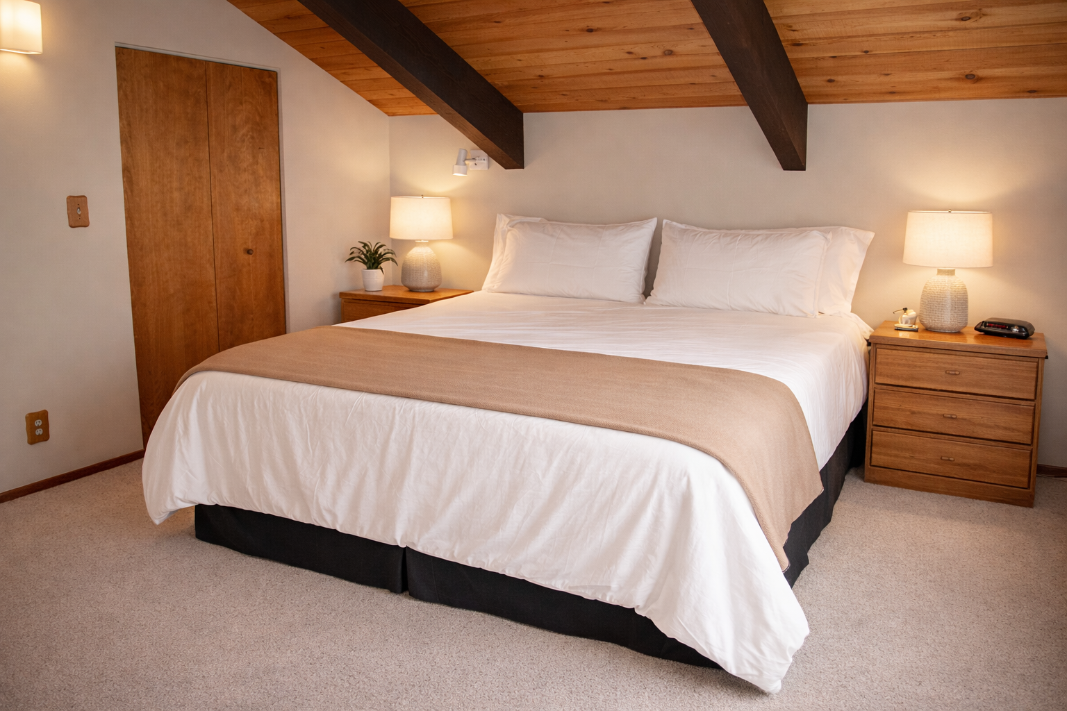 Rest in your cozy bedroom featuring exposed wood beams, crisp linens, and warm bedside lighting creating the perfect retreat.