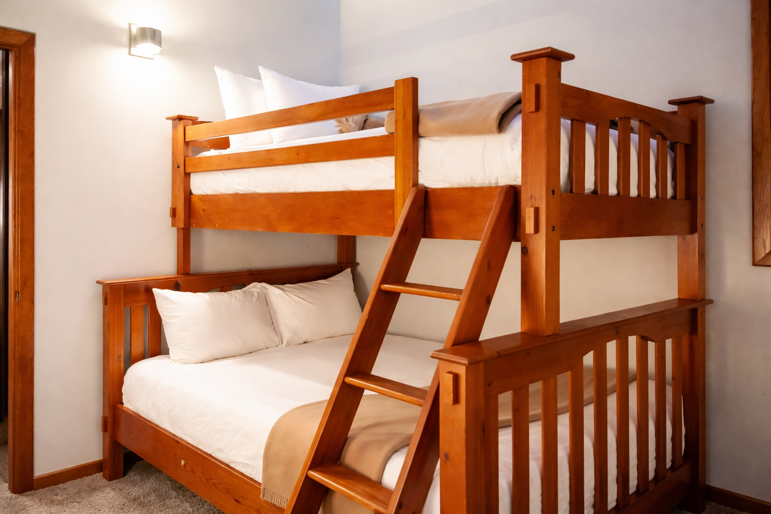 Sleep soundly in this sturdy wooden bunk bed with crisp linens and cozy touches for your family getaway.