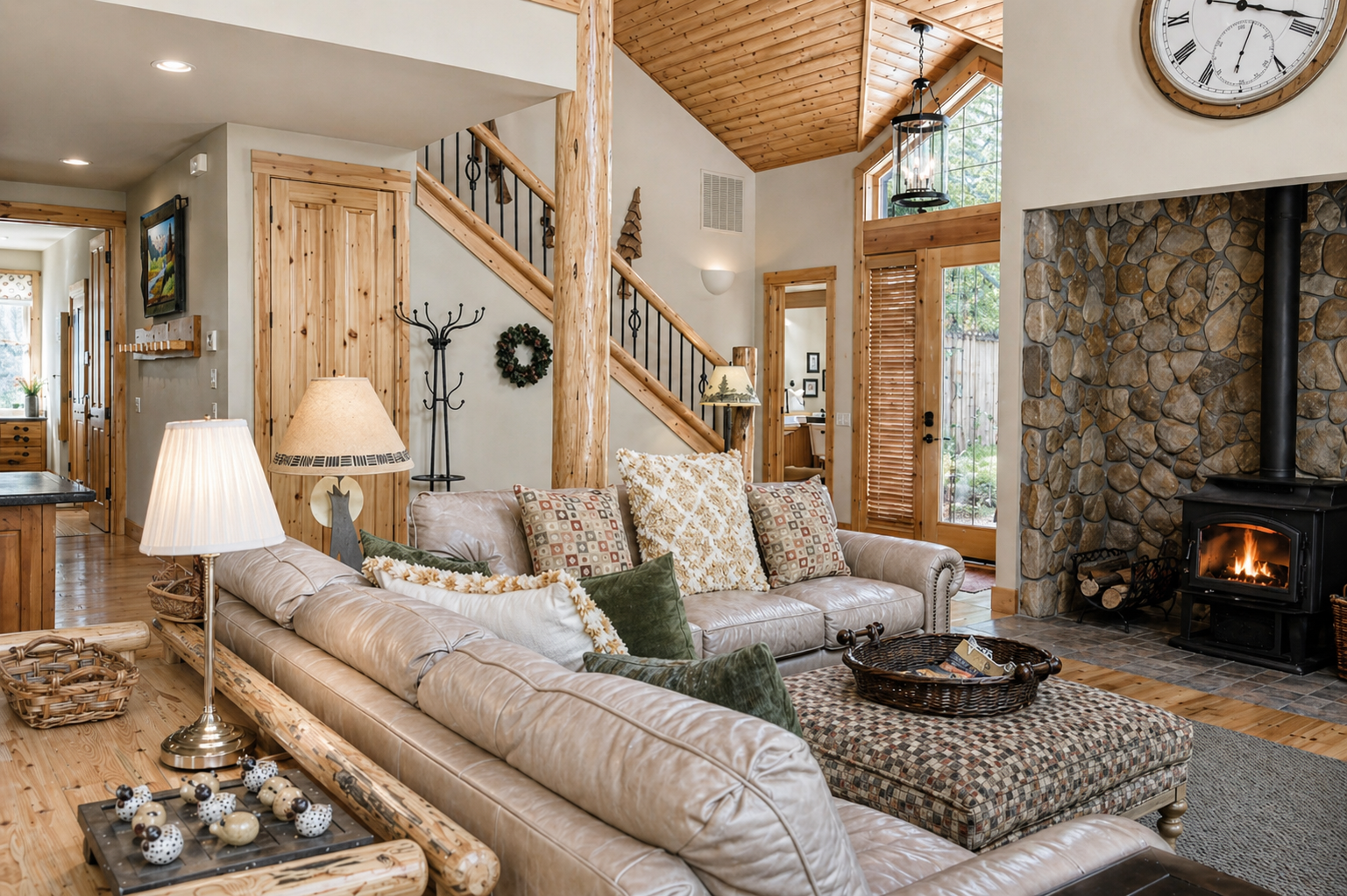 Curl up by your crackling stone fireplace in this cozy living room with rustic wood beams and comfortable seating.