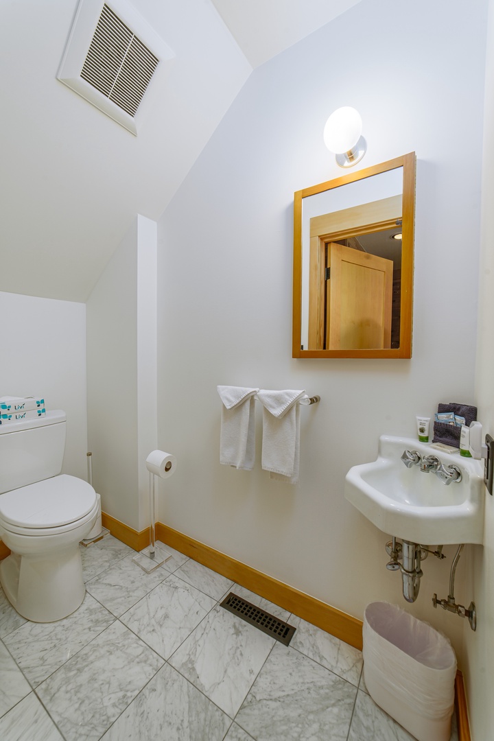 Your private bathroom features fresh towels, a pedestal sink, and clean finishes for your comfort and convenience.