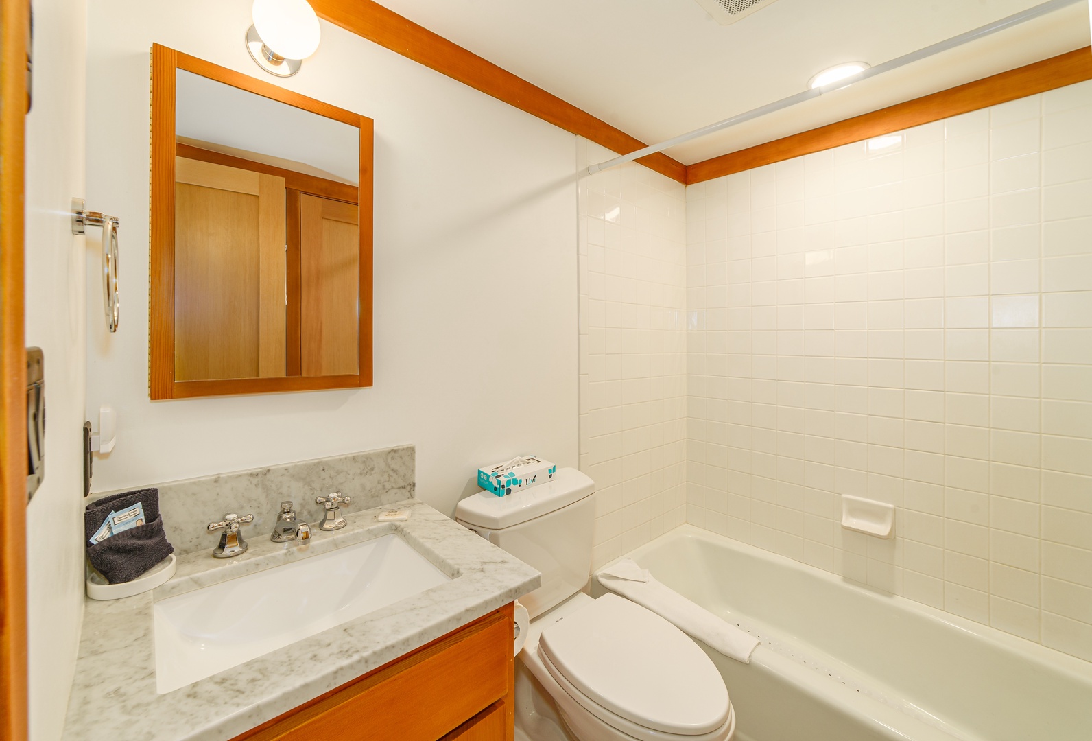 Step into your private bathroom featuring marble counters, warm wood accents, and a relaxing tub-shower combo for unwinding after your adventures.