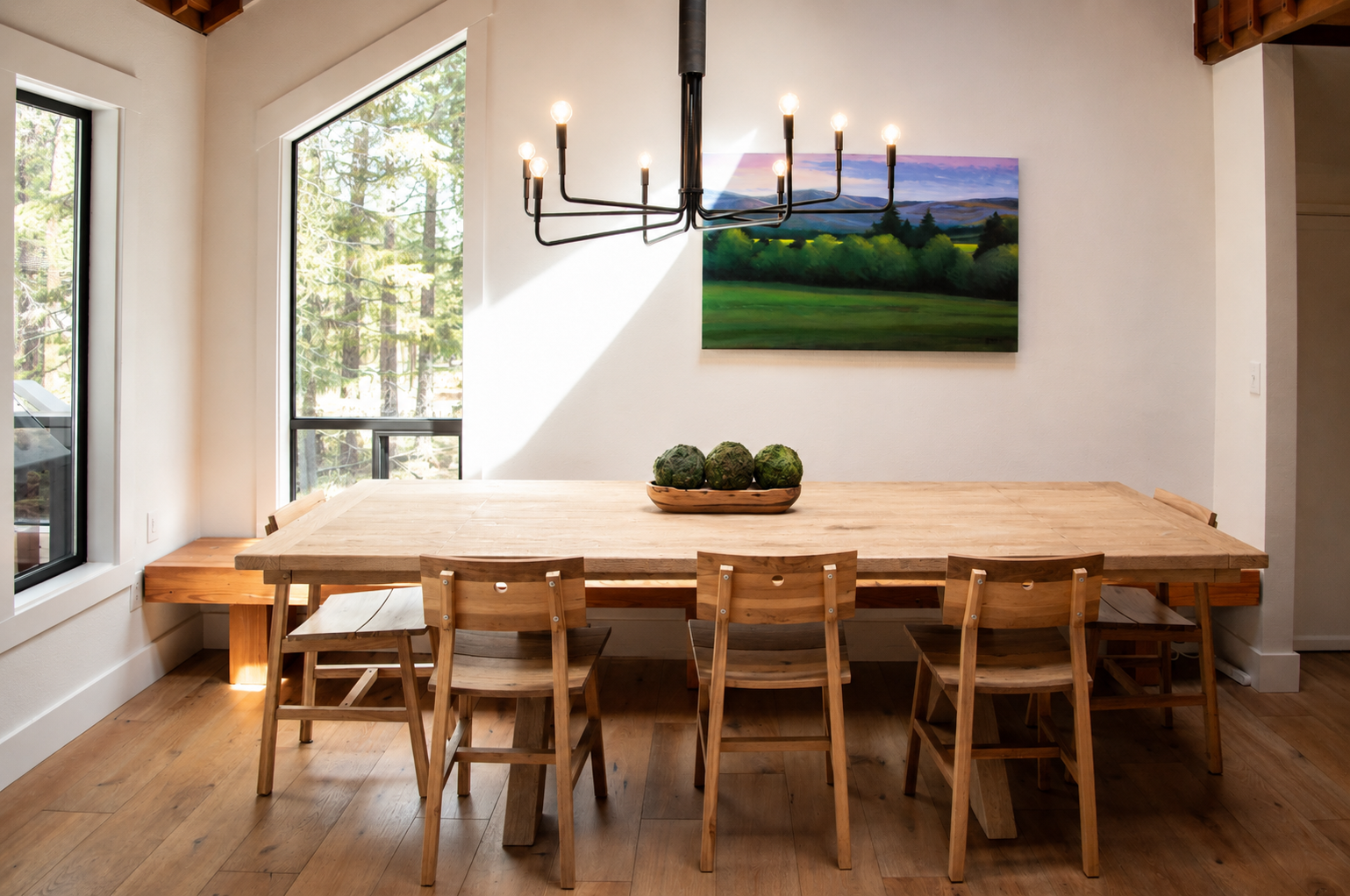 Gather around this warm, sun-filled dining space where natural wood and forest views invite you to share memorable meals. Rustic charm meets modern comfort for your perfect retreat.