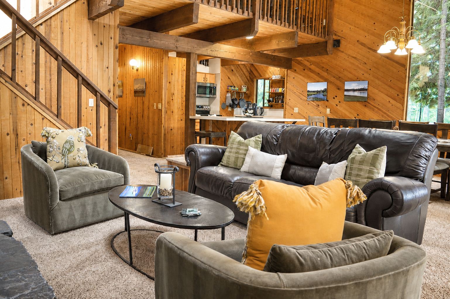 Settle into plush seating under soaring wood beams—your cozy retreat features an open living area flowing into a full kitchen and lofted upper level, perfect for family gatherings.