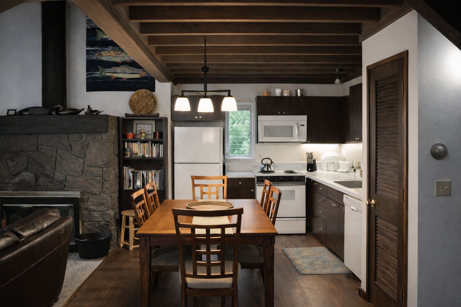 Your cozy mountain retreat combines rustic charm with modern convenience—gather around the warm stone fireplace after preparing meals in your fully-equipped kitchen.