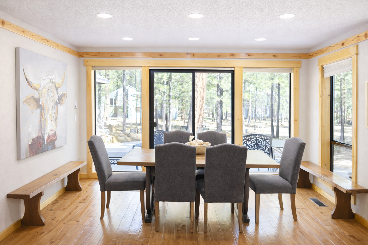 Gather around your spacious dining table with stunning forest views through floor-to-ceiling windows, creating the perfect backdrop for memorable meals together.