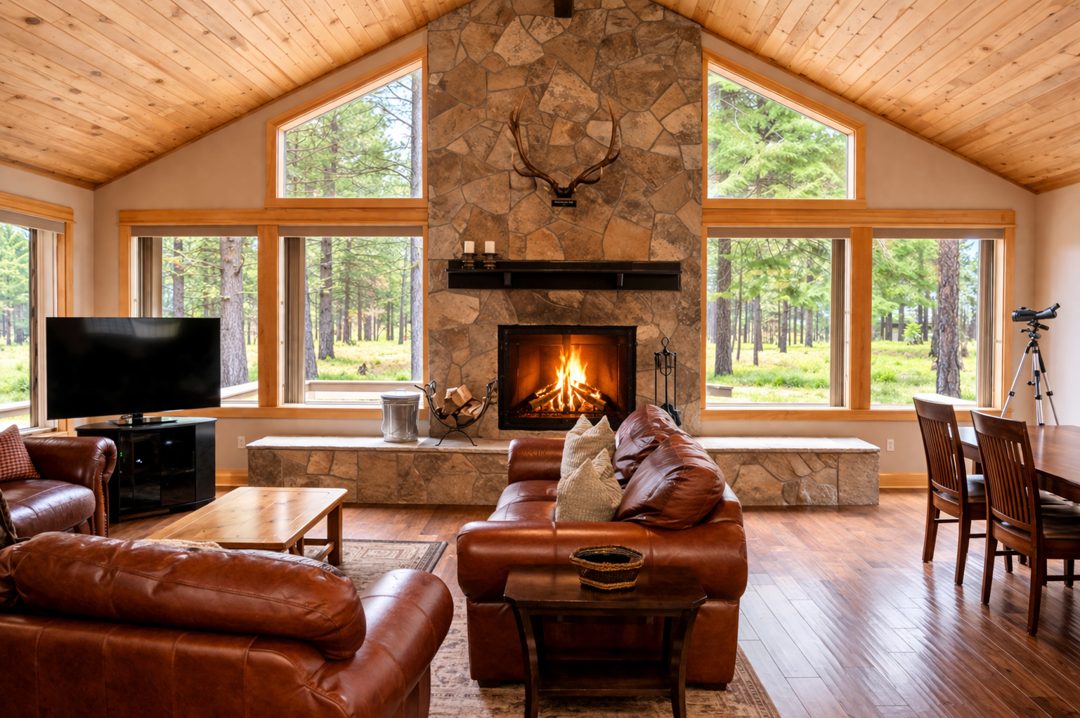 Cozy up by your crackling stone fireplace while watching deer through floor-to-ceiling windows overlooking the peaceful forest.