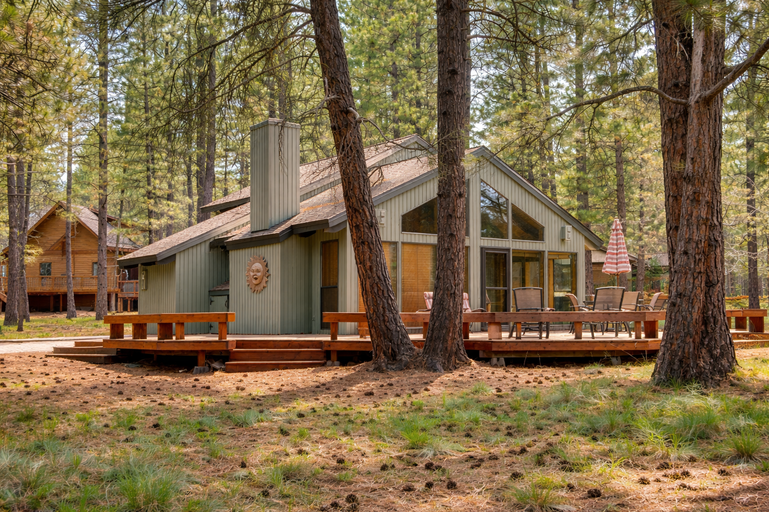 Charming forest retreat nestled among towering pines with spacious deck for outdoor dining and relaxation.