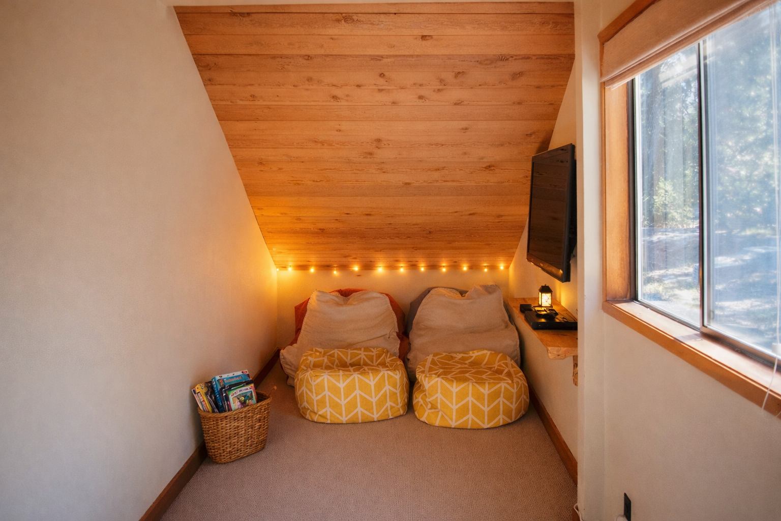 Cozy up in your private reading nook with warm fairy lights casting a gentle glow over comfortable cushions and mountain views.