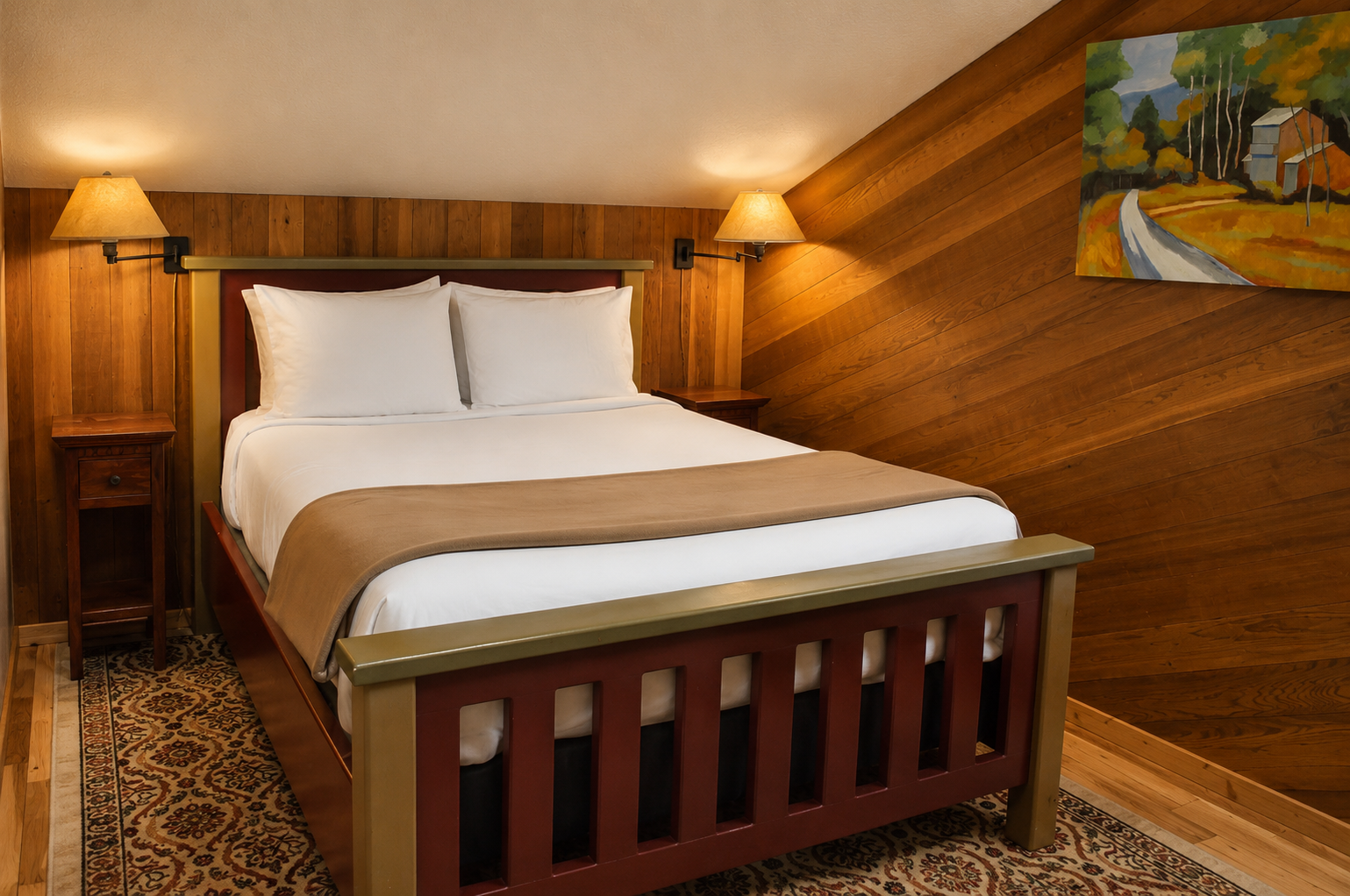 Slip into crisp white linens and sink into the warmth of this cozy wood-paneled retreat, where soft lighting and thoughtful touches create your perfect mountain escape.