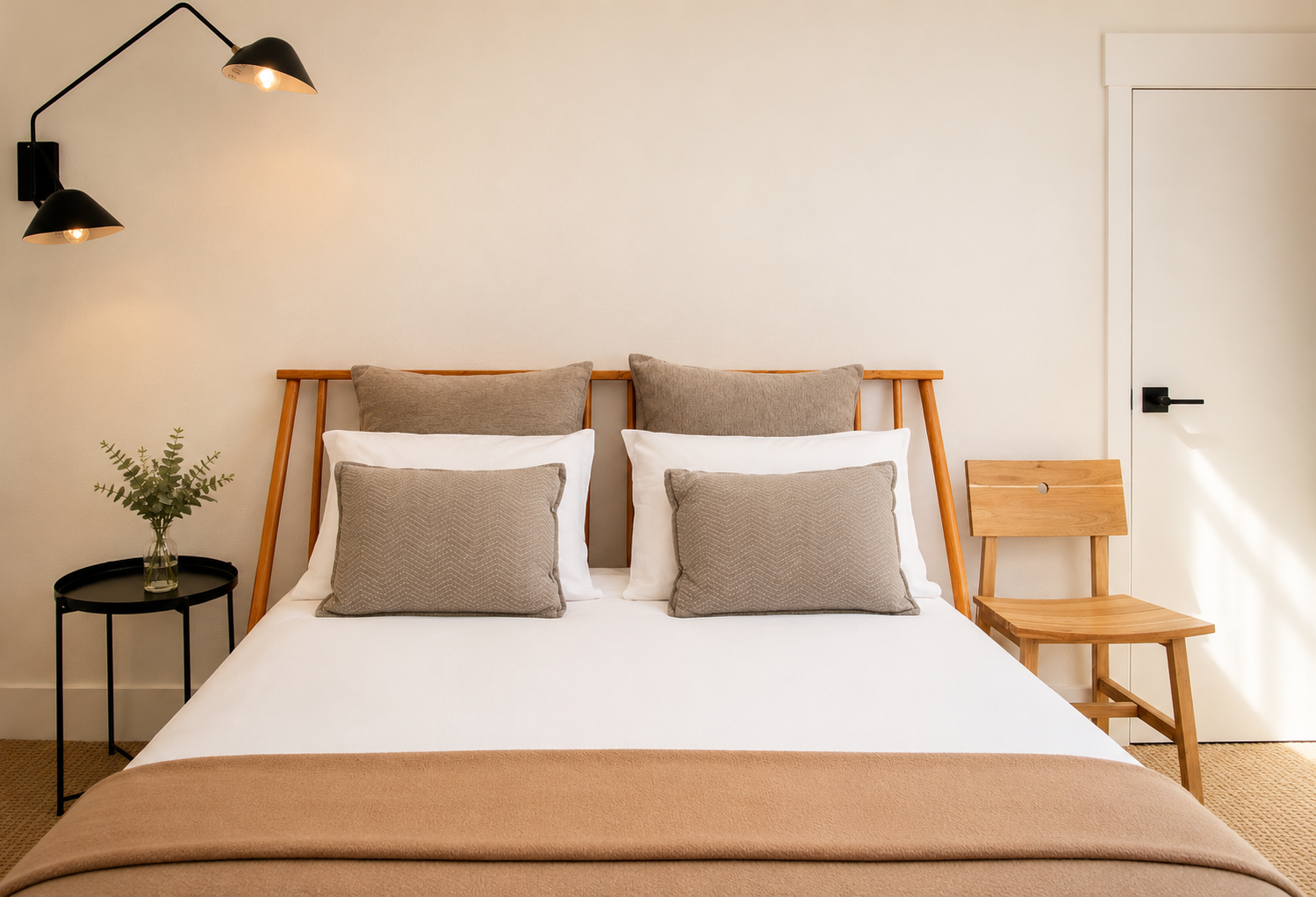 Sink into crisp white linens and plush pillows in your serene bedroom retreat, where natural wood accents and warm lighting create the perfect ambiance for restful nights.