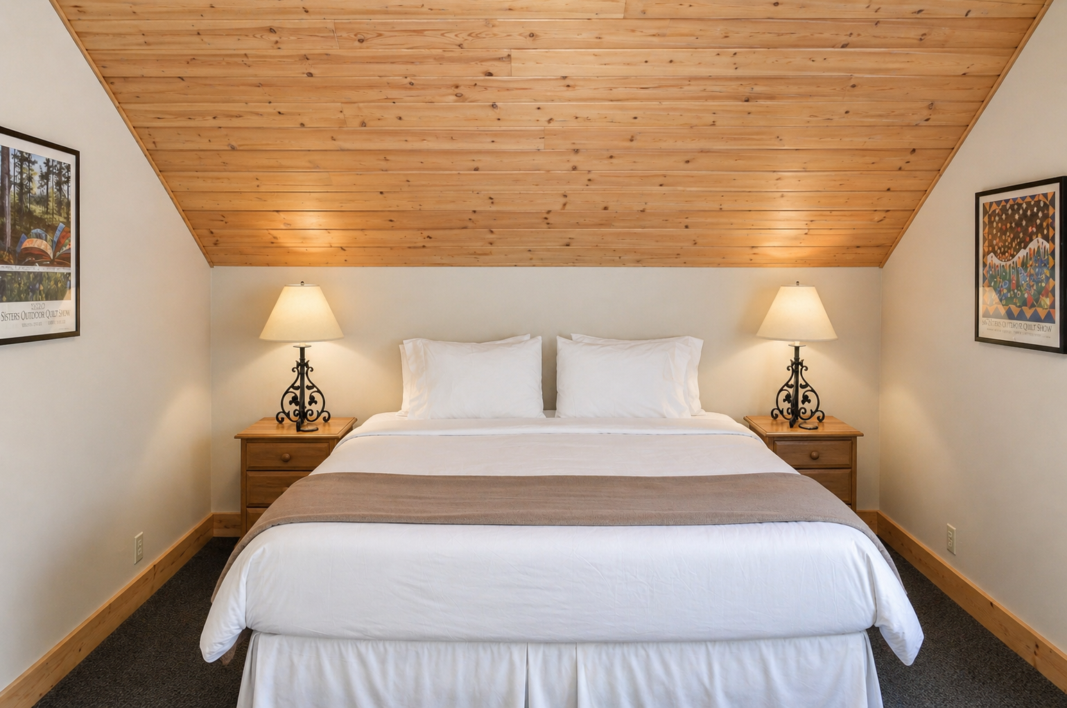 Drift into restful sleep beneath charming wood-paneled ceilings, where soft linens and warm bedside lighting create your cozy mountain retreat.
