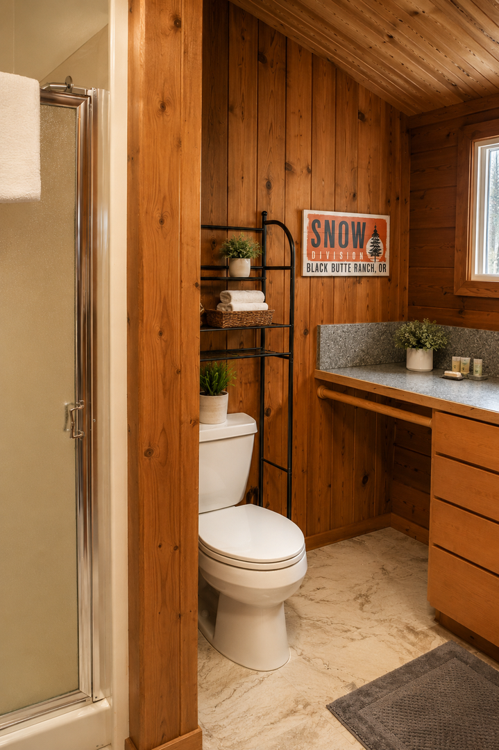 Warm wood paneling and thoughtful details create a cozy, mountain-inspired bathroom where you can unwind after your adventures.