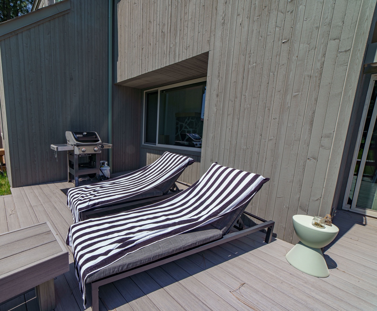 Soak up the sunshine on your private deck with striped loungers and BBQ grill ready for memorable outdoor meals.