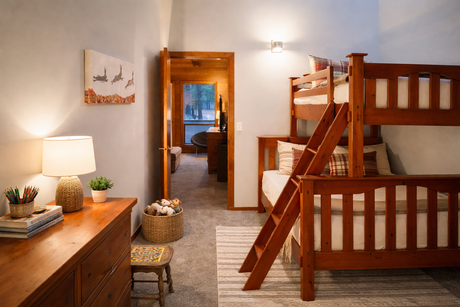 Cozy up in your charming bunk room where warm wood tones and thoughtful touches create the perfect family retreat for restful nights.