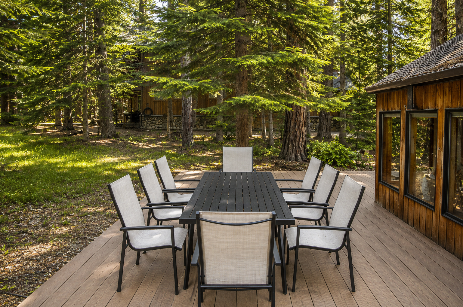 Peaceful woodland surroundings provide the perfect backdrop for the private deck and spacious outdoor dining table, ideal for morning coffee or evening meals under the pines.