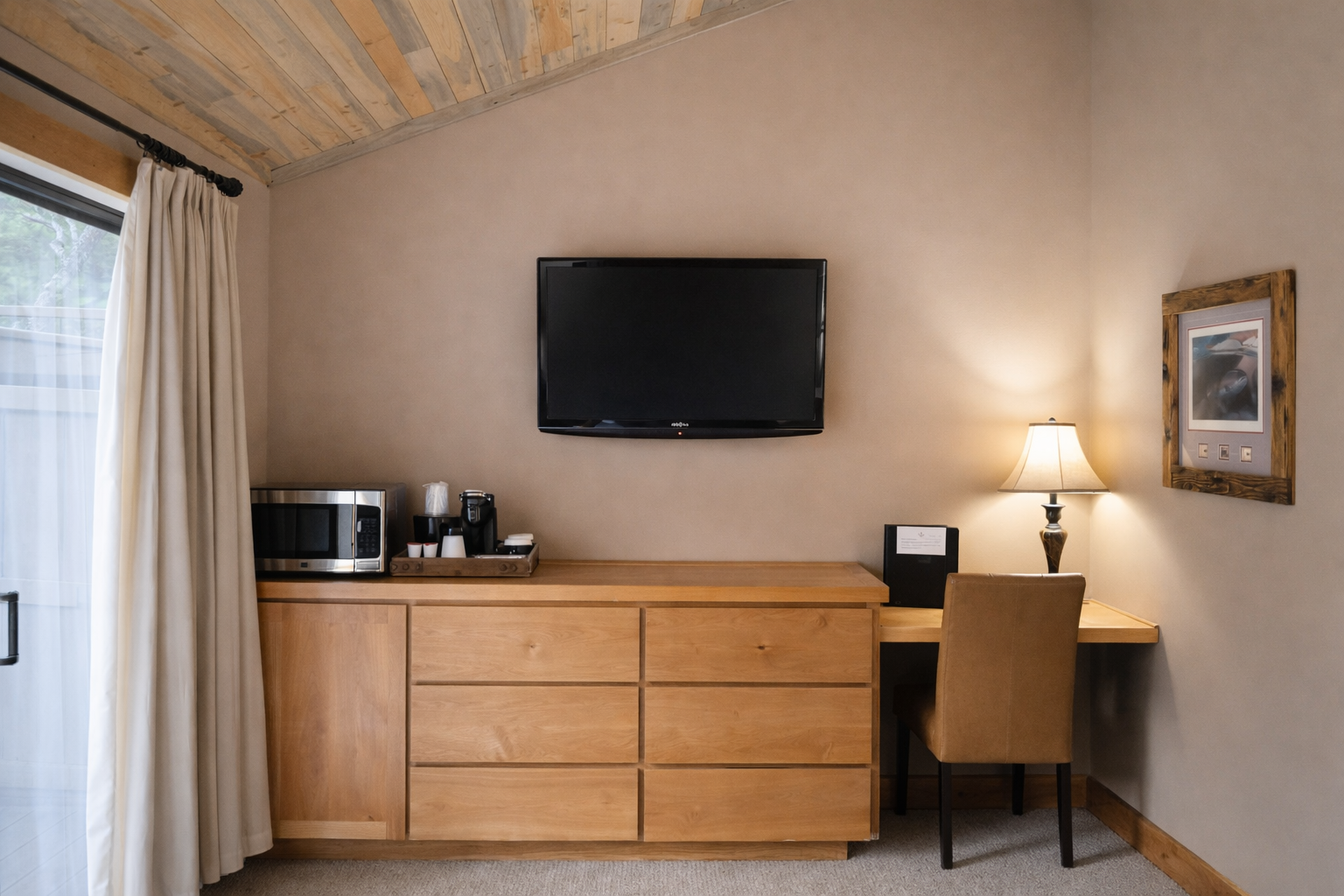 Unwind in your serene retreat featuring rustic wood beams, modern amenities, and a cozy workspace perfect for mountain getaway relaxation.