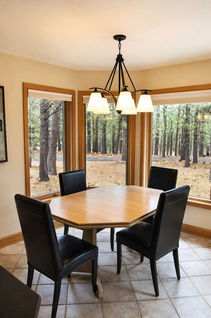 Gather around this inviting table and enjoy meals with forest views framing every moment through expansive windows that bring nature right to your dining experience.