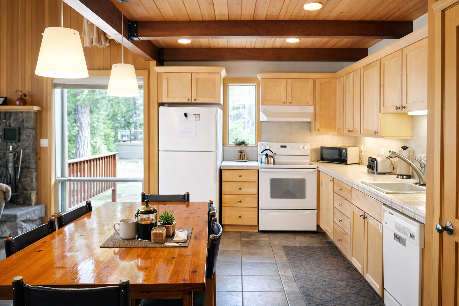 Your fully-equipped kitchen awaits with warm wood cabinets, modern appliances, and charming exposed beams—perfect for cooking memorable meals during your stay.