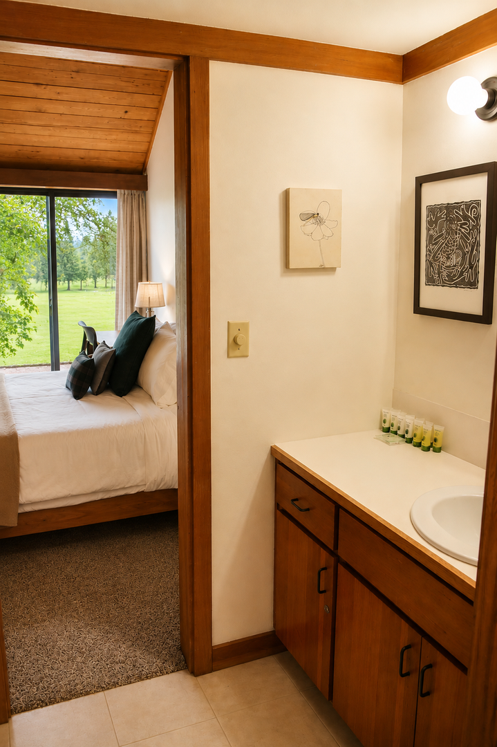 Your private retreat blends warm wood tones with peaceful garden views—just steps from your cozy bed to the refreshing ensuite vanity, with thoughtful amenities awaiting.