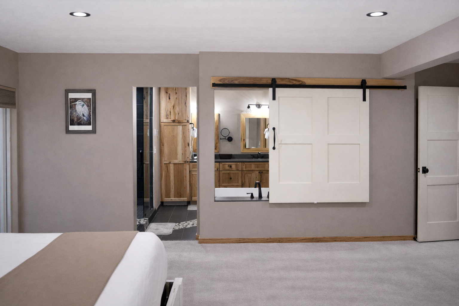 Unwind in your luxurious master suite featuring a stunning barn door entrance to your private spa-like bathroom retreat.