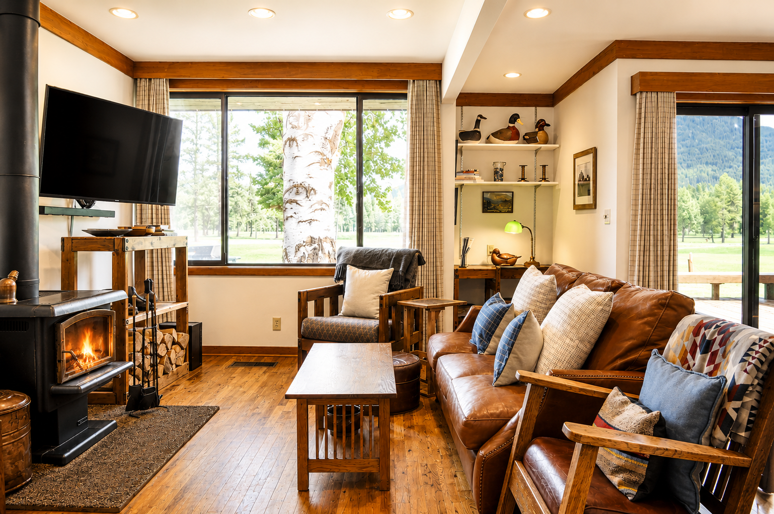 Sink into the plush leather sofa by your crackling fireplace, with mountain and meadow views framing your cozy retreat—perfect for unwinding after a day exploring the great outdoors.