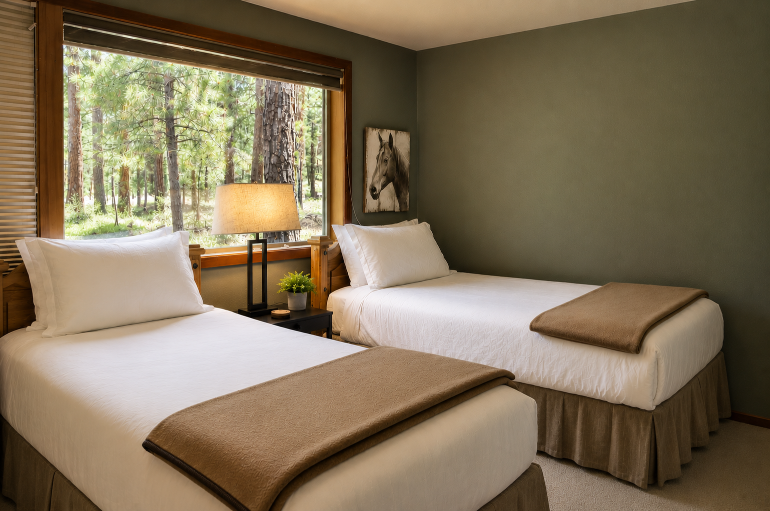Your cozy twin bedroom features plush bedding, a warm lamp, and a peaceful window framing serene forest views, perfect for unwinding after a day of adventure.