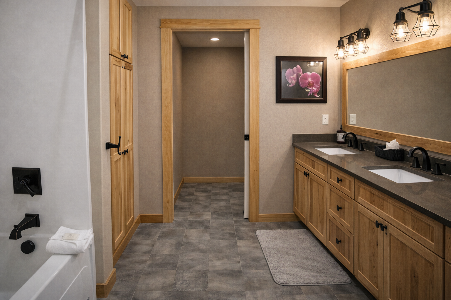 Unwind in your spacious bathroom featuring dual sinks, elegant wood cabinetry, and a luxurious soaking tub perfect for relaxing after your adventures.