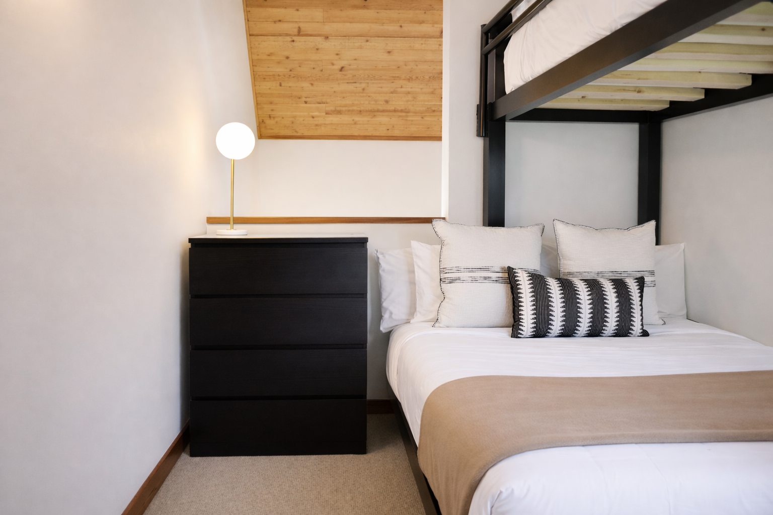 Drift off in your cozy bedroom featuring crisp linens, warm wood accents, and modern touches that create the perfect retreat.