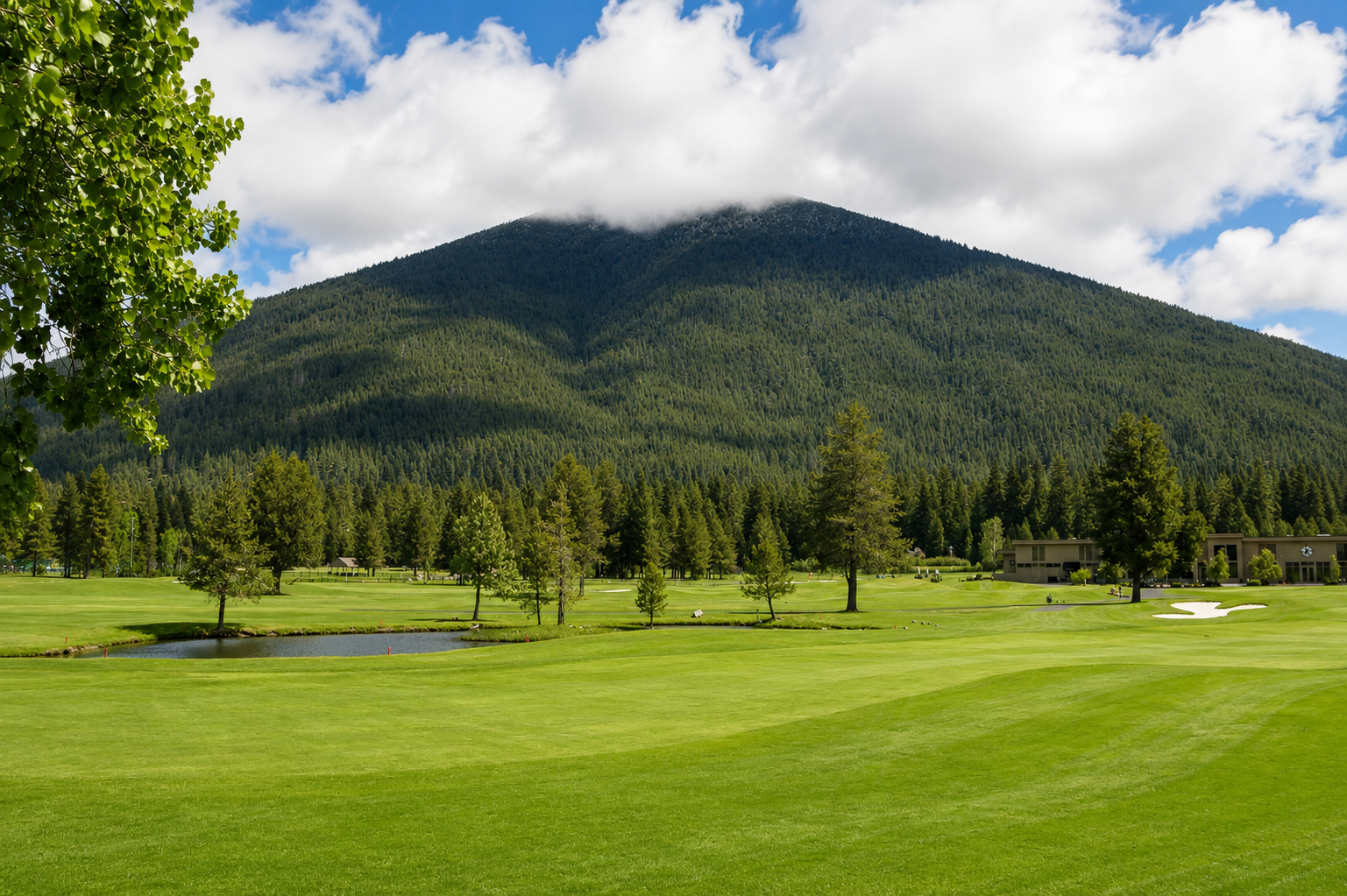 Scenic golf course set against a forested mountain backdrop, part of the property's surrounding natural landscape and nearby recreational amenities.