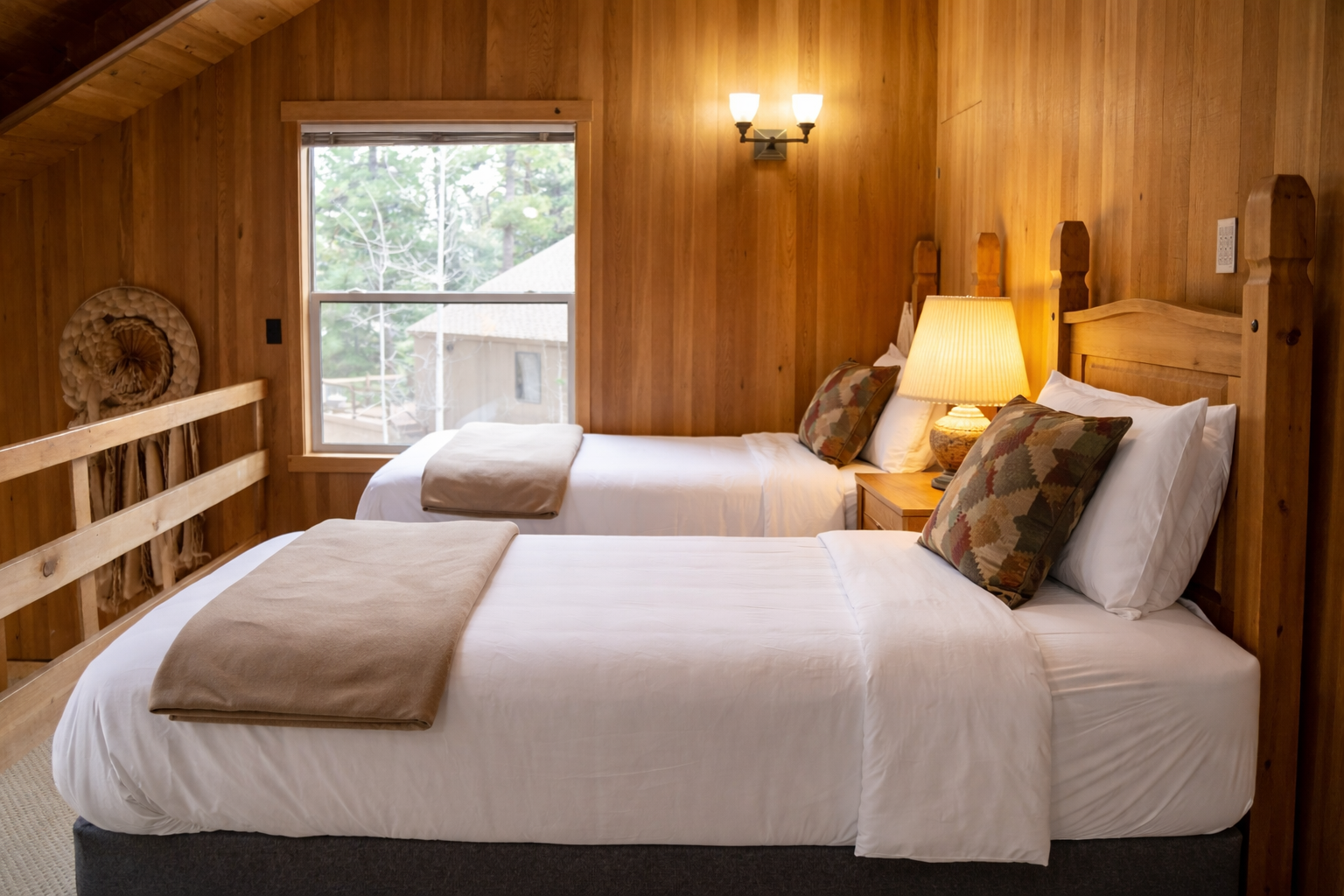 Cozy twin beds welcome you in this rustic wood-paneled loft bedroom, where soft lighting creates the perfect mountain retreat ambiance.