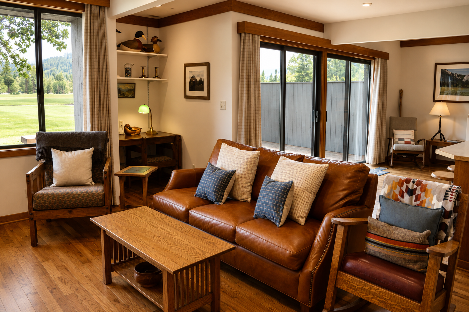 Sink into plush leather seating and enjoy views of lush greens through expansive windows. Your cozy retreat features warm wood tones, thoughtful lighting, and a peaceful golf course backdrop perfect for unwinding.