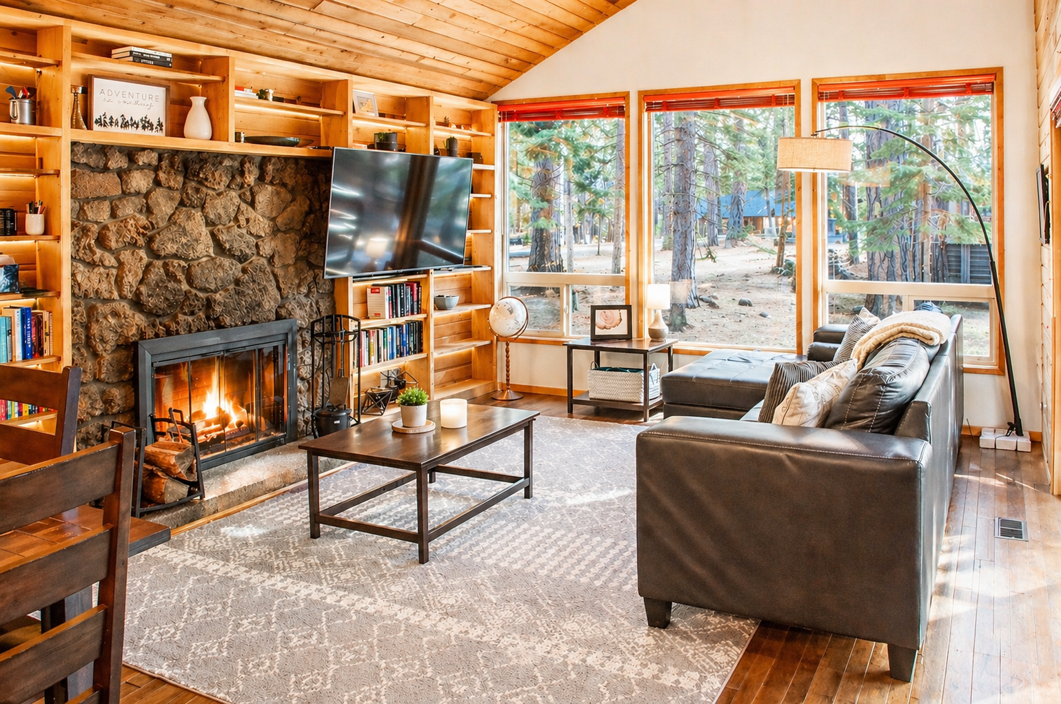 Cozy up by your crackling fireplace while forest views frame your peaceful retreat through expansive windows.