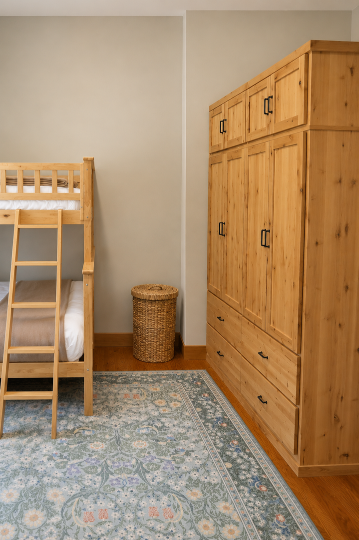 Your cozy bedroom features warm pine furniture, including bunk beds and a spacious wardrobe for all your belongings. Perfect for families or friends traveling together in comfort.