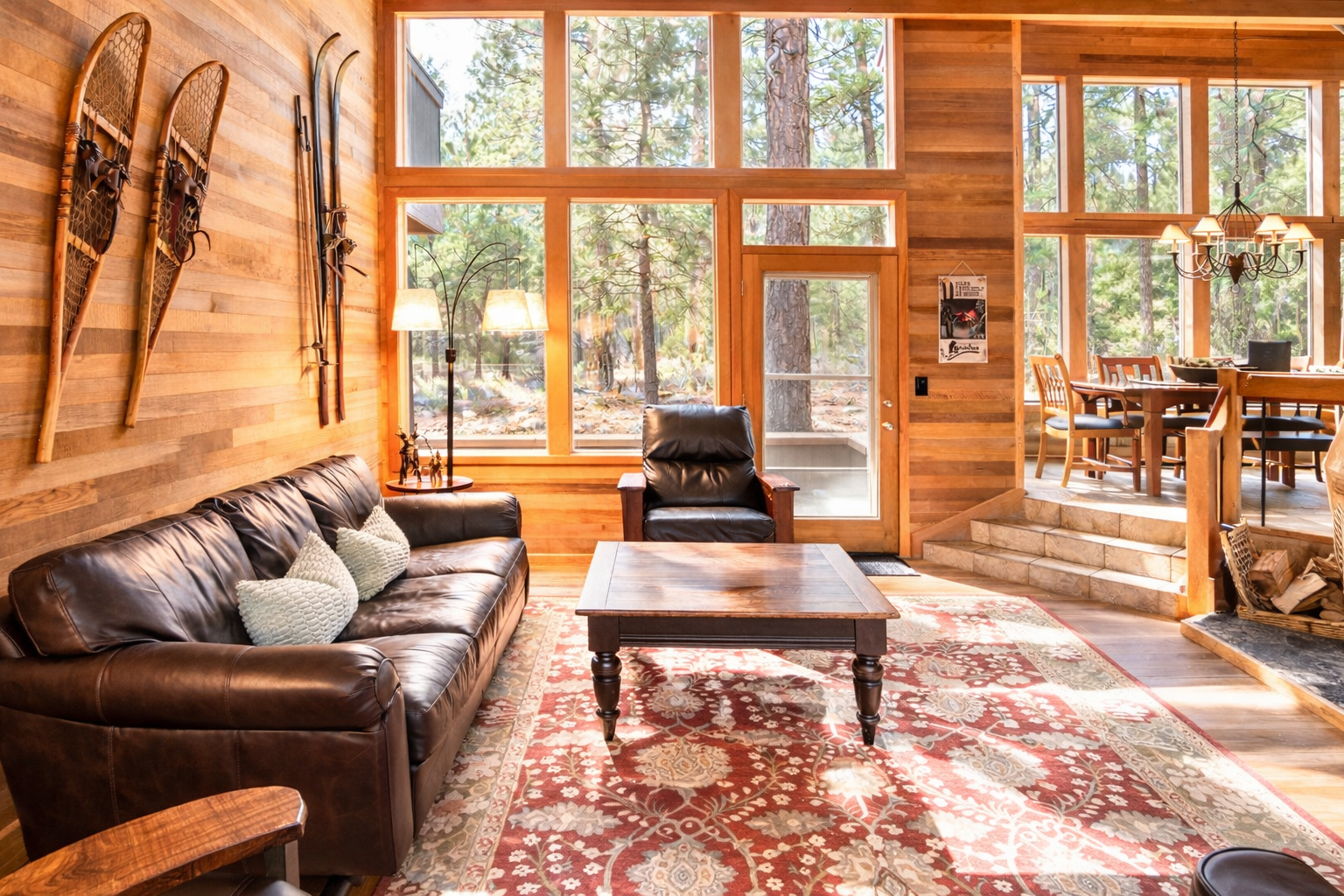 Sink into rich leather seating while admiring vintage snowshoes adorning warm wood walls, creating your perfect mountain retreat sanctuary.