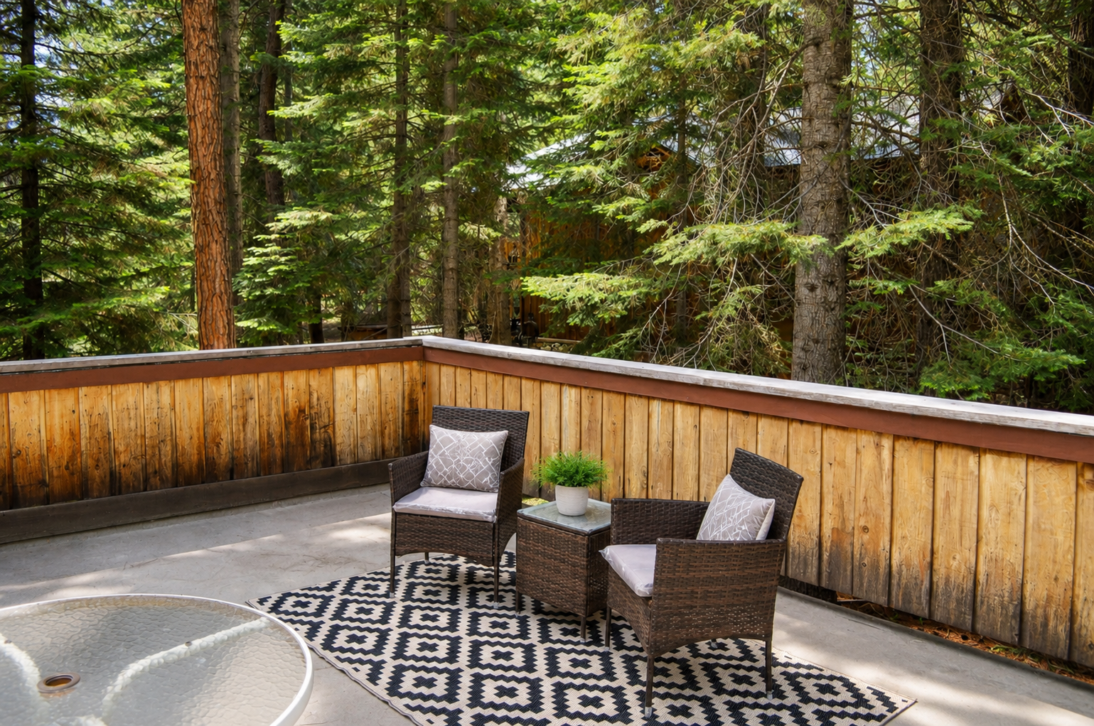 Unwind on your private patio surrounded by towering pines. This cozy outdoor retreat offers a peaceful escape where you can sip morning coffee or soak in the forest views.