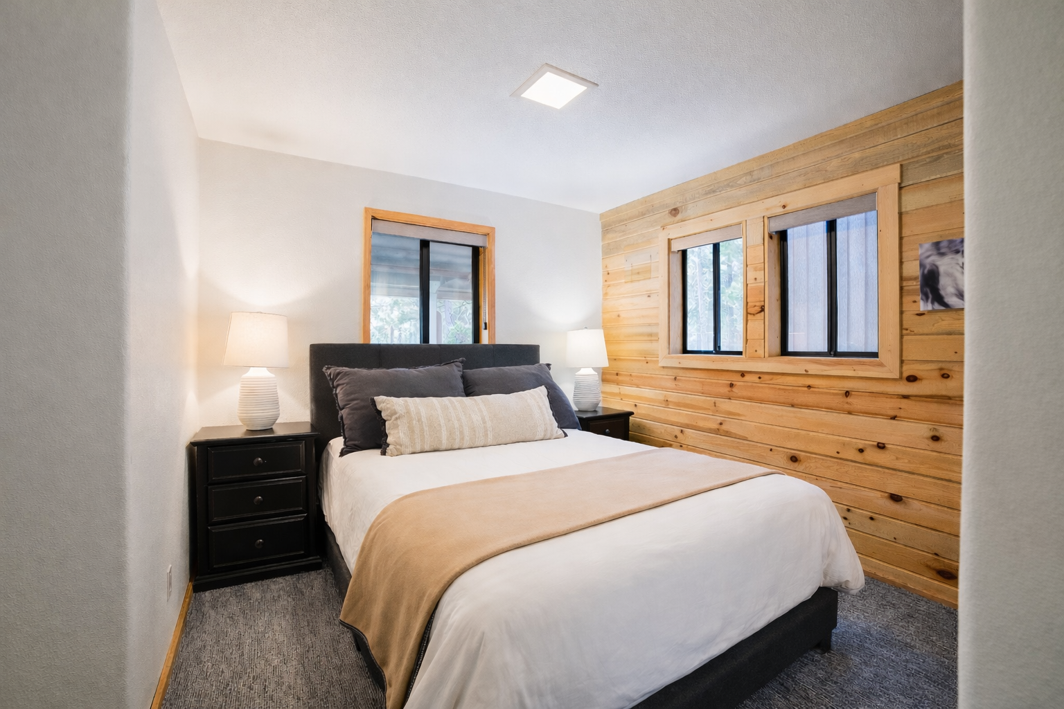 Sink into soft linens and wake to natural light streaming through your windows in this cozy bedroom retreat.