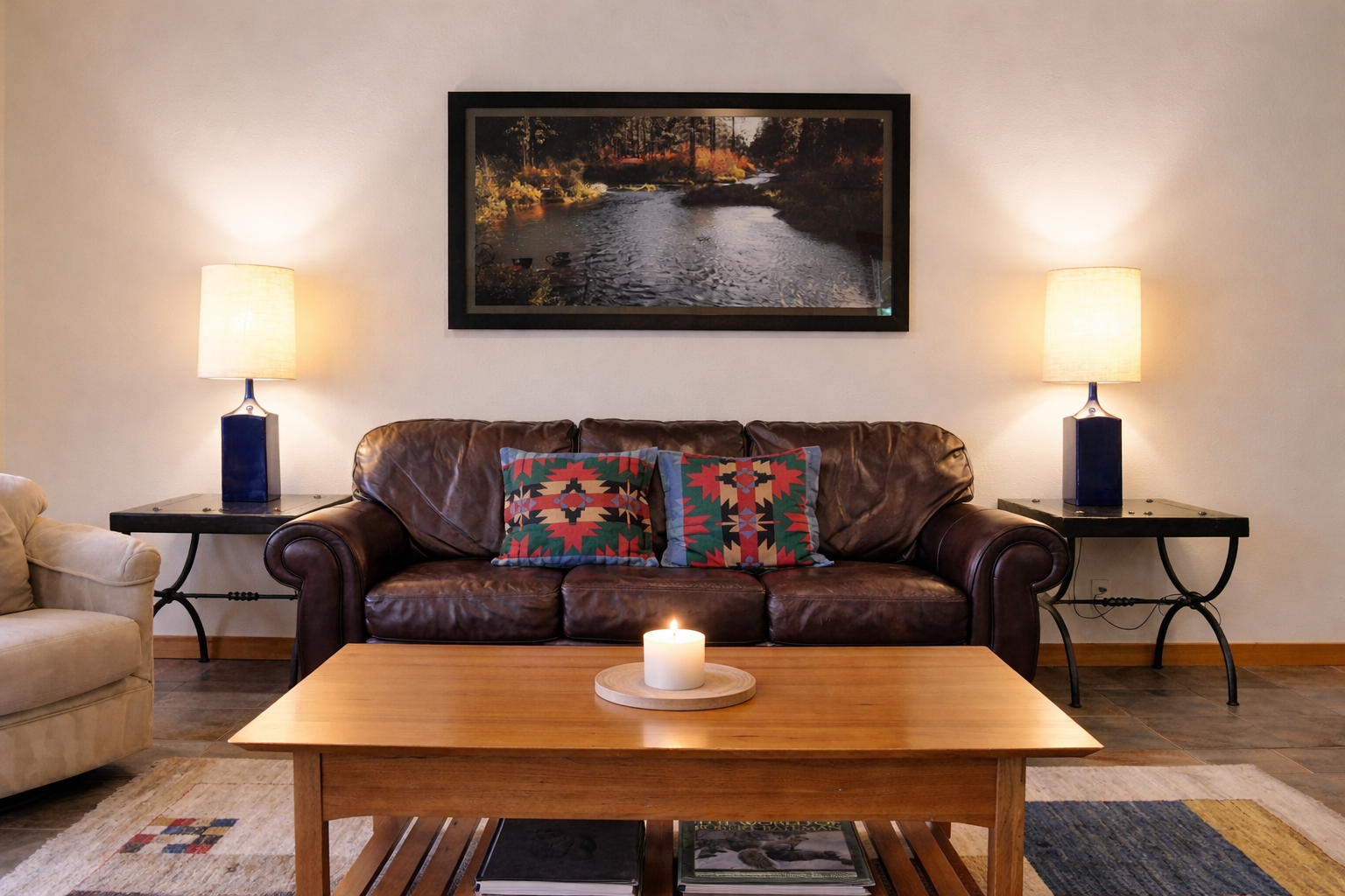 Sink into this cozy leather sofa where warm lighting and thoughtful decor create your perfect evening retreat.