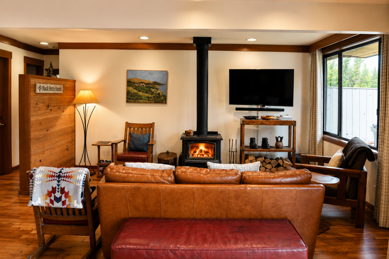 Settle into the warmth of your living space, where a crackling fireplace and plush leather seating invite you to unwind after exploring the outdoors.