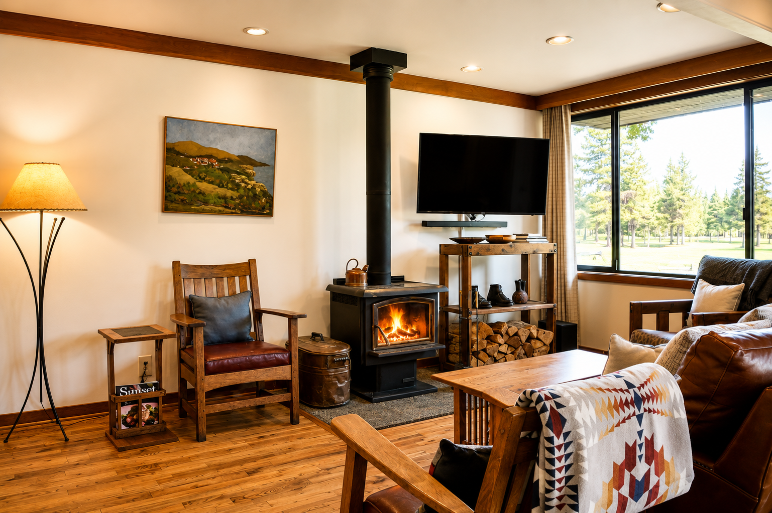 Curl up in this inviting living room where a crackling fireplace, plush leather seating, and natural wood accents create your perfect cozy retreat surrounded by stunning forest views.