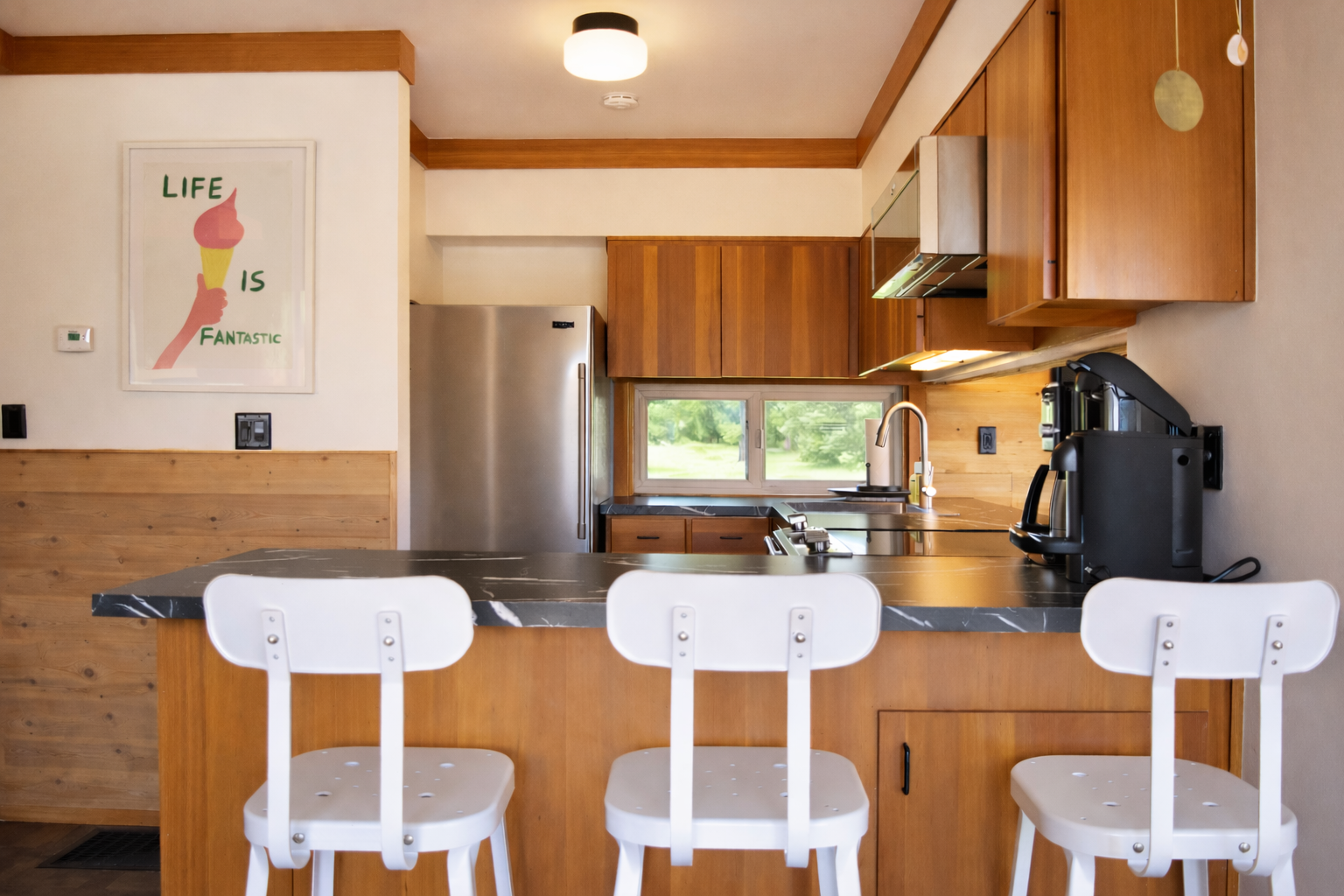 Your kitchen awaits with warm wood cabinets and a breakfast bar where you can sip morning coffee while planning your adventures.