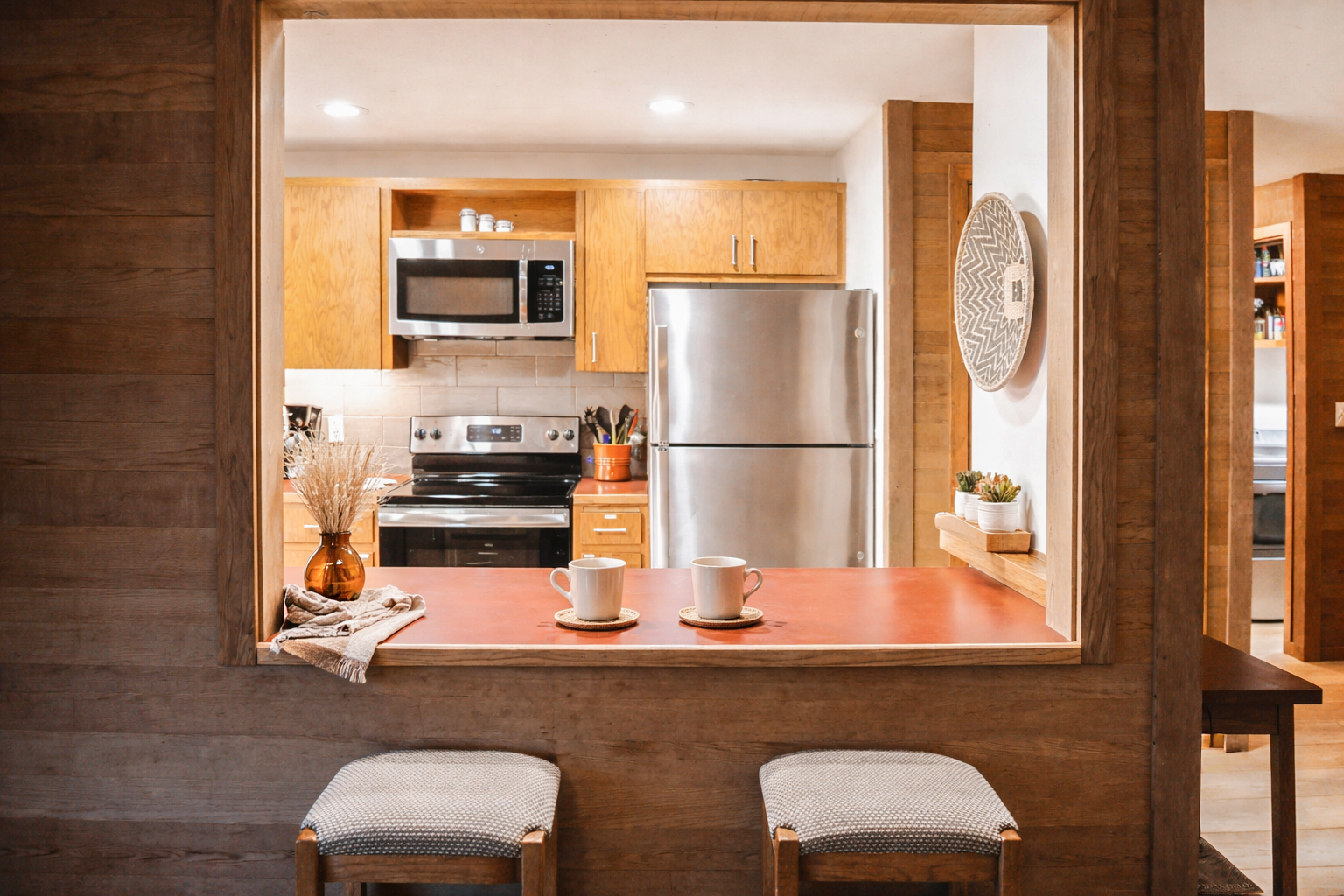 Your stylish kitchen opens through a breakfast bar, creating perfect flow for morning coffee and casual meals together.