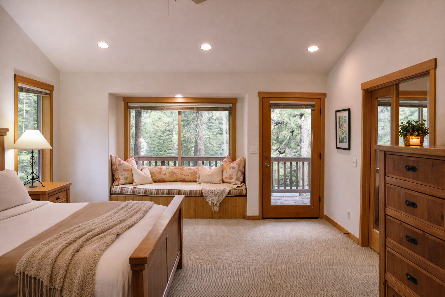 Drift off in your cozy bedroom with forest views, featuring a window seat perfect for morning coffee and private balcony access.