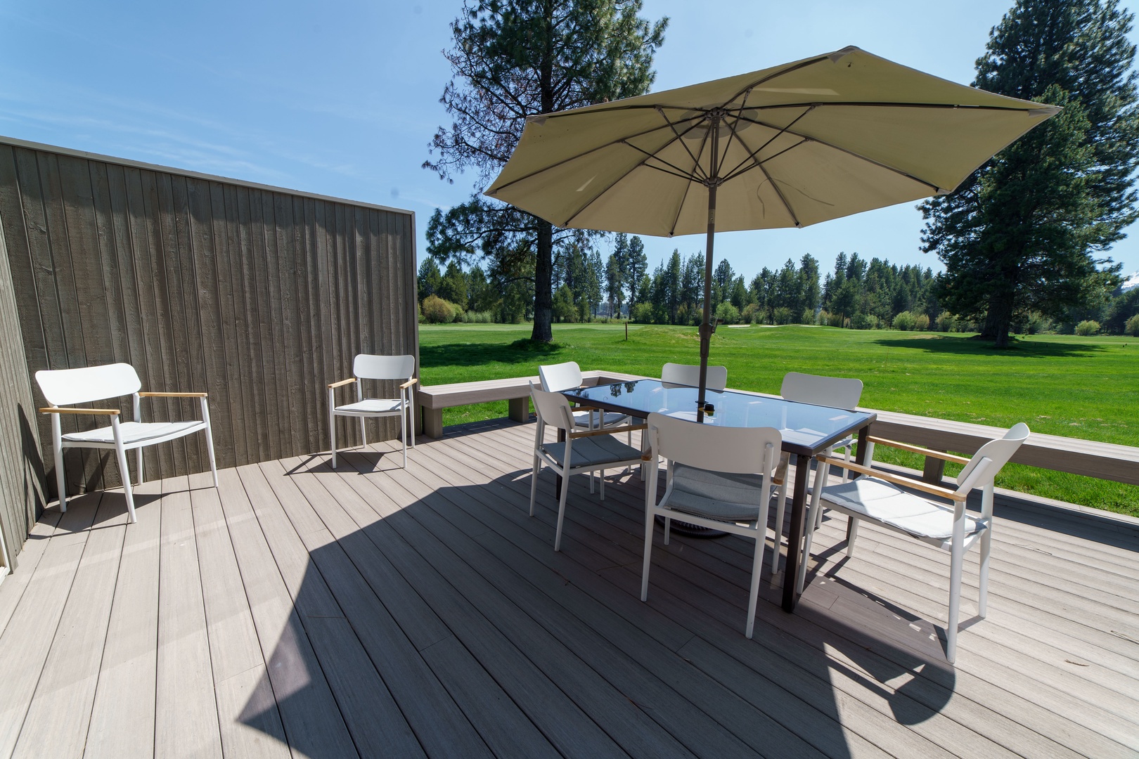 Your private deck overlooks endless green lawns where you'll savor morning coffee and evening dinners under the shade umbrella.