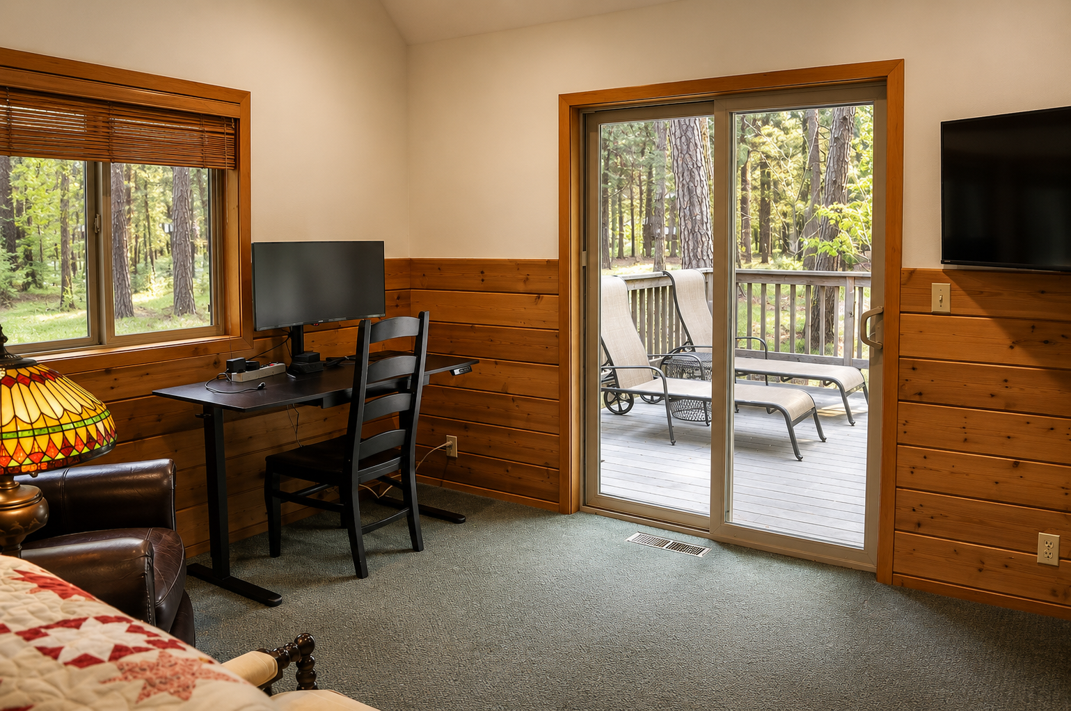 Step into your cozy retreat with warm wood paneling, a workspace by the window, and your private balcony overlooking peaceful pines—perfect for morning coffee or unwinding at day's end.