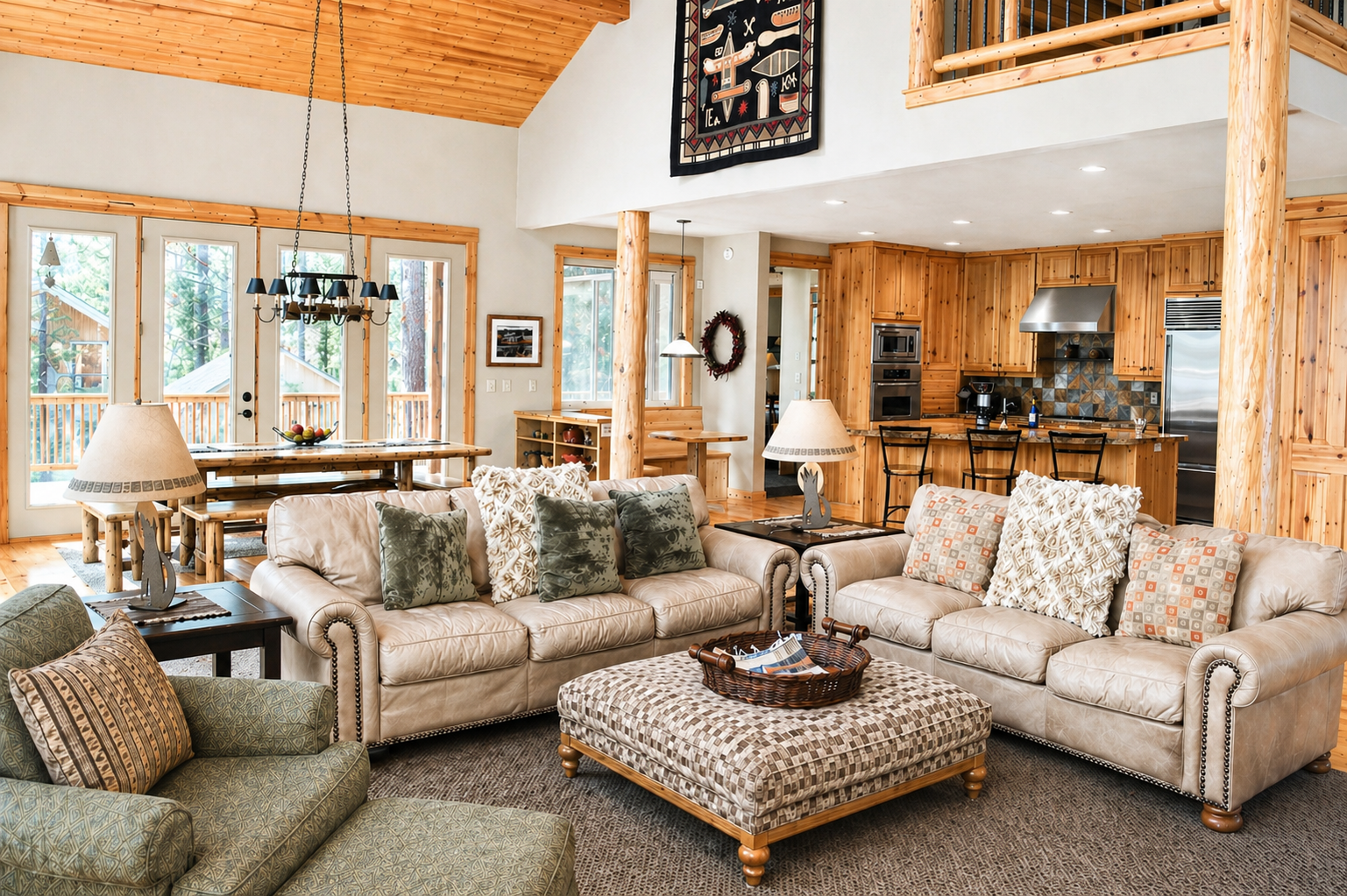 Unwind in this spacious open-concept living area with soaring ceilings, warm wood accents, and mountain views from every window.