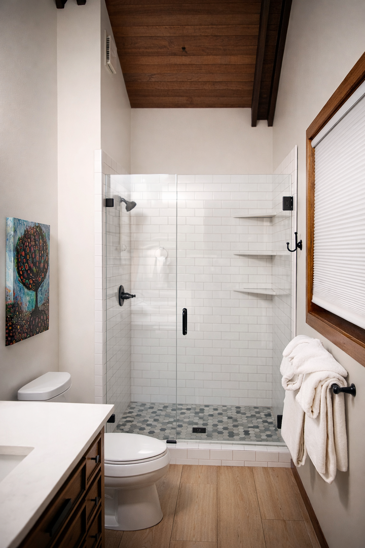 Step into your private spa-like bathroom featuring a spacious walk-in shower with elegant subway tiles and fluffy towels awaiting.